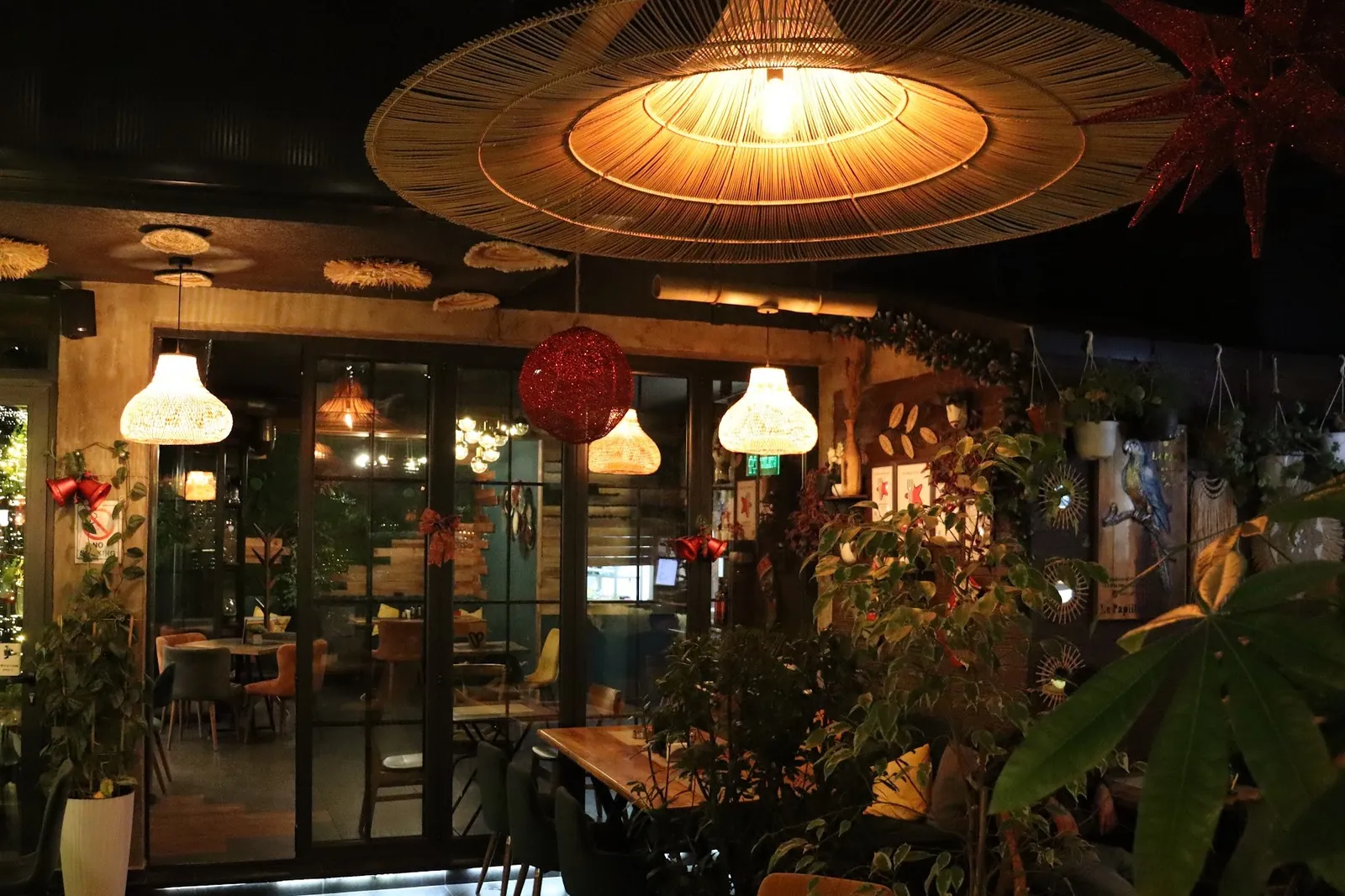 The lounge at night under woven pendant lamps